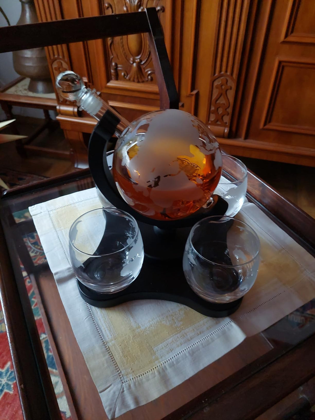 globe decanter 4 glasses with whiskey in house