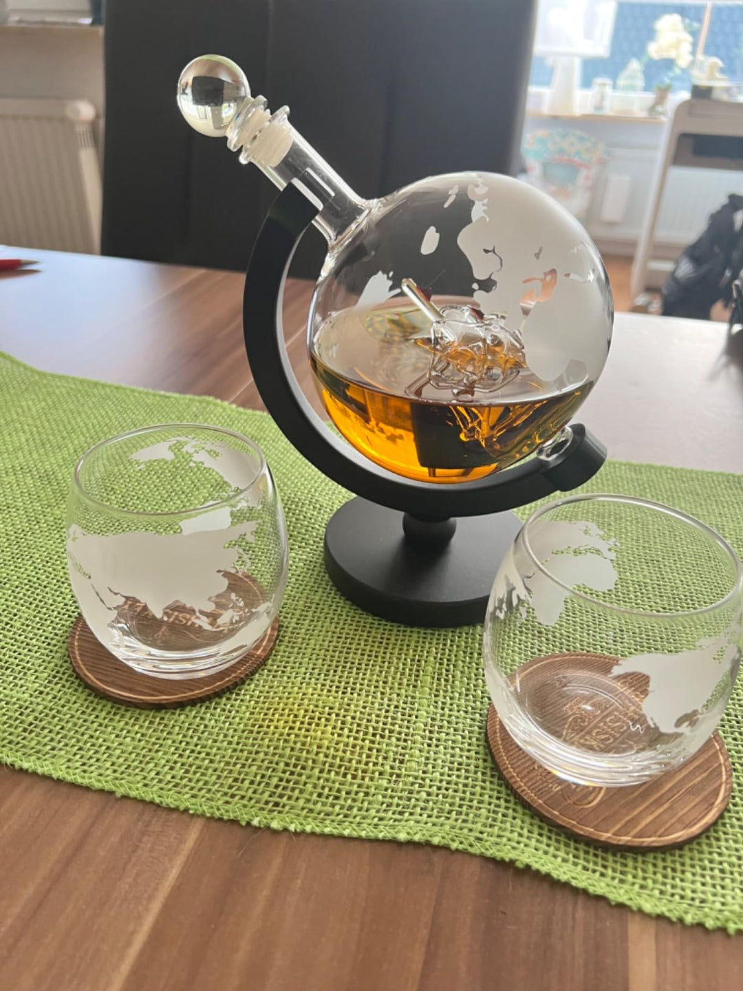 globe decanter on table with two glasses and whiskey