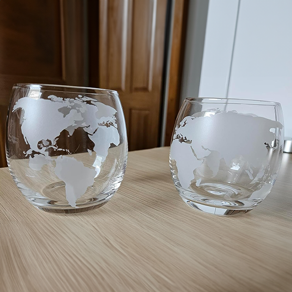 two_world_map_glasses_on_table